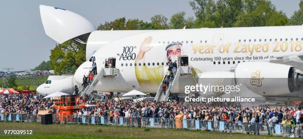 Dpatop - 28 April 2018, Germany, Schoenefeld: Many visitors walking through the ILA 2018 - with an Airbus A380 with special markings showing Sheikh...