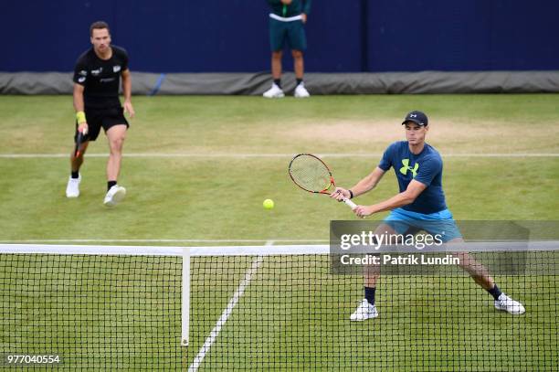 Jamie Murray of Great Britain hits a backhand in practice with Bruno Soares of Brazil during qualifying Day 2 of the Fever-Tree Championships at...