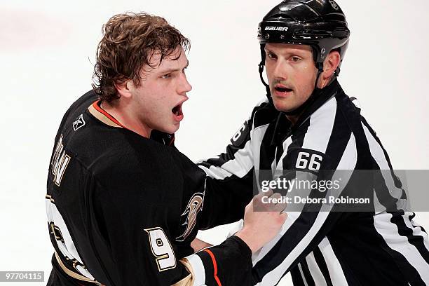 Bobby Ryan of the Anaheim Ducks is yells at Dan Boyle of the San Jose Sharks as linesman Darren Gibbs pushes him away during the game on March 14,...