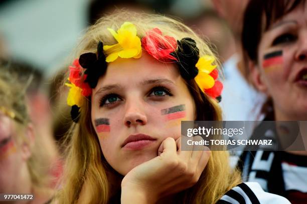 Fan of the German team wearing colors of the German national flag watches the Russia 2018 World Cup Group F football match between Germany and Mexico...