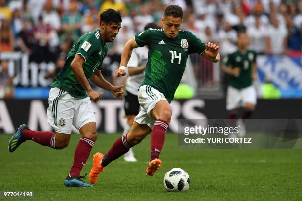 Mexico's forward Javier Hernandez drives the ball past Mexico's forward Carlos Vela during the Russia 2018 World Cup Group F football match between...