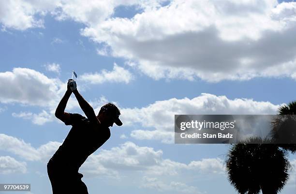 Charl Schwartzel of South Africa hits from the fourth tee box during the final round of the World Golf Championships-CA Championship at Doral Golf...