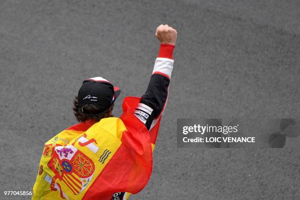 Toyota TS050 Hybrid LMP1 Spain's driver Fernando Alonso celebrates after winning the 86th Le Mans 24-hours endurance race, at the Circuit de la...