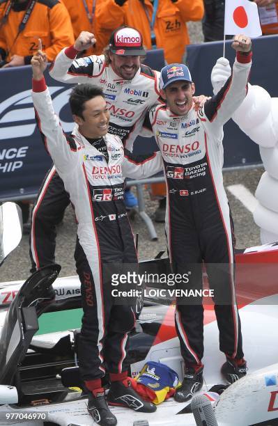 Toyota TS050 Hybrid LMP1's drivers Spain's Fernando Alonso , Japan's Kazuki Nakajima and Switzerland's Sebastien Buemi celebrate after winning the...