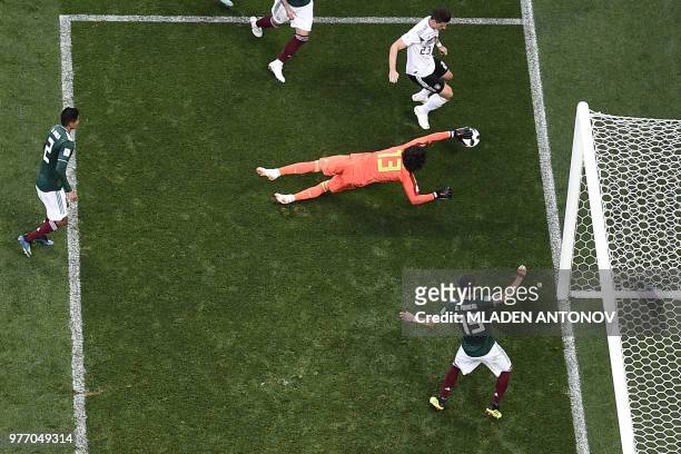Mexico's goalkeeper Guillermo Ochoa dives to save a shot by Germany's forward Mario Gomez during the Russia 2018 World Cup Group F football match...