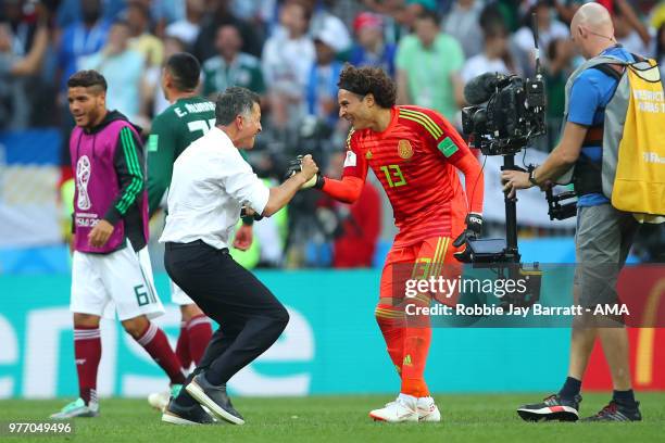 Juan Carlos Osorio head coach / manager of Mexico celebrates with Guillermo Ochoa at the end of the 2018 FIFA World Cup Russia group F match between...