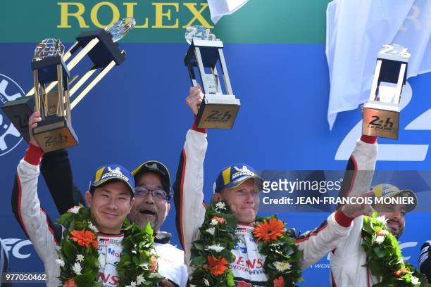 Toyota TS050 Hybrid LMP1 Japan driver Kamui Kobayashi , British driver Mike Conway and Argentinian driver Jose Maria Lopez celebrate placing second...