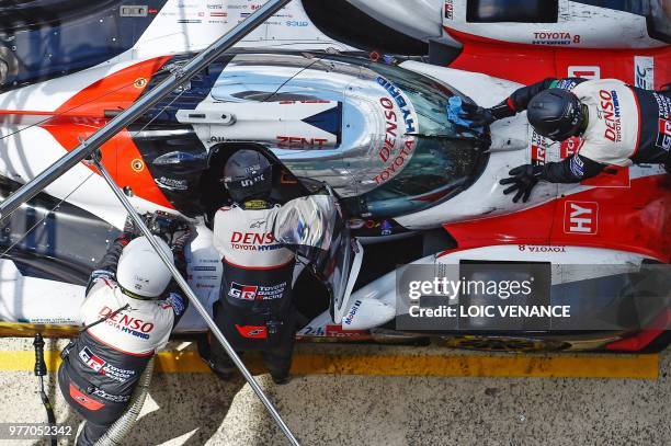 Toyota TS050 Hybrid LMP1 Japanese's driver Kazuki Nakajima stops his car in the pits before to win the 86th Le Mans 24-hours endurance race, at the...