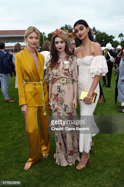Martha Hunt, Lily Collins and Neelam Gill attend the Cartier Queen's Cup Polo at Guards Polo Club on June 17, 2018 in Egham, England.