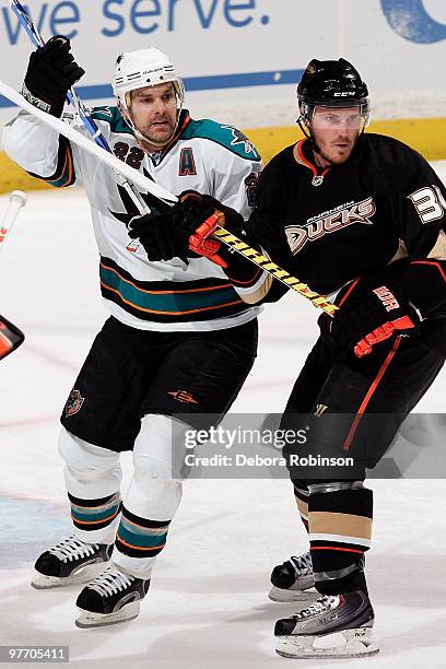 Dan Boyle of the San Jose Sharks battles for position against James Wisniewski of the Anaheim Ducks during the game on March 14, 2010 at Honda Center...
