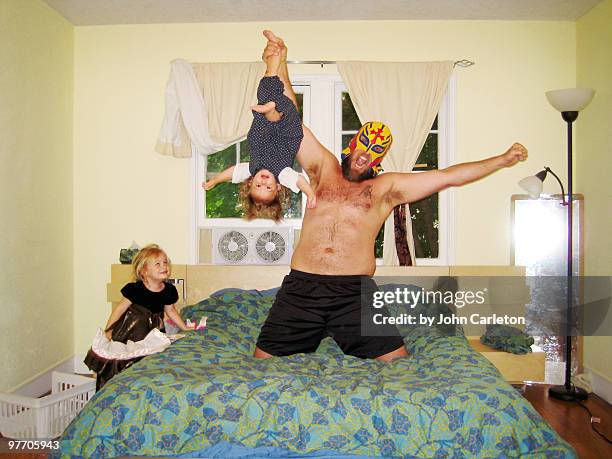 wrestler dad plays with his kids - rough housing stockfoto's en -beelden