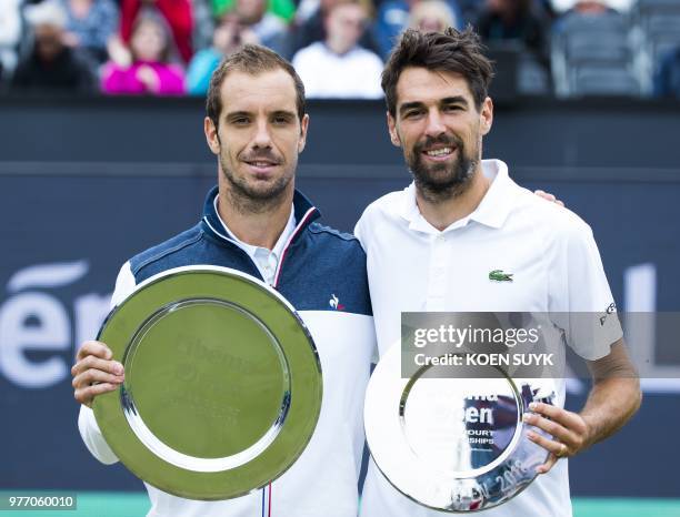 France's Richard Gasquet celebrates stands along side compatriot Jeremy Chardy after winning the Men's final of the Libema Open tennis tournament in...