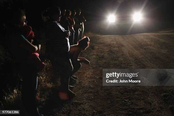 Central American asylum seekers, including a Honduran girl and her mother , are taken into custody near the U.S.-Mexico border on June 12, 2018 in...