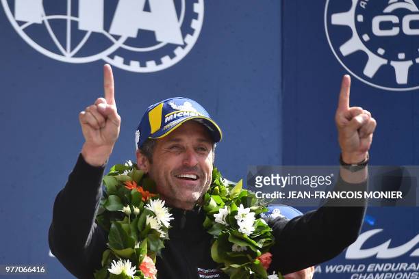 Actor and co-owner of team Dempsey-Proton racing, Patrick Dempsey reacts on the podium after his team won the LM GTE category during the 86th Le Mans...