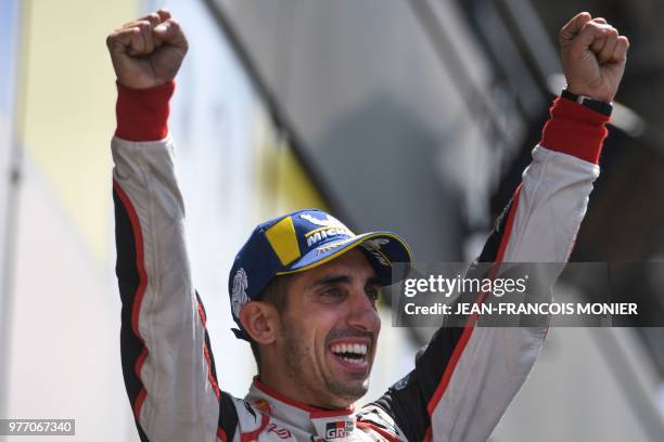 Swiss driver Sebastien Buemi celebrates on the podium after he and his co-drivers won the 86th Le Mans 24-hours endurance race, at the Circuit de la...