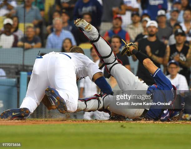 Matt Kemp of the Los Angeles Dodgers is out at the plate as he collides with Robinson Chirinos of the Texas Rangers in the third inning at Dodger...