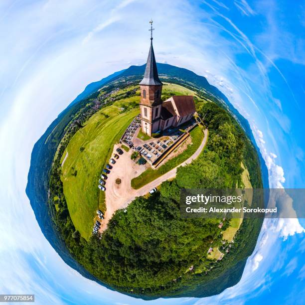 little planet aerial panoramic view of little church in vosges mountains, alsace, france. sunny summer day. eglise saint-gilles de saint-pierre-bois. - architecture bois stockfoto's en -beelden