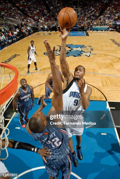 Rashard Lewis of the Orlando Magic shoots in the paint against Theo Ratliff of the Charlotte Bobcats during the game on March 14, 2010 at Amway Arena...