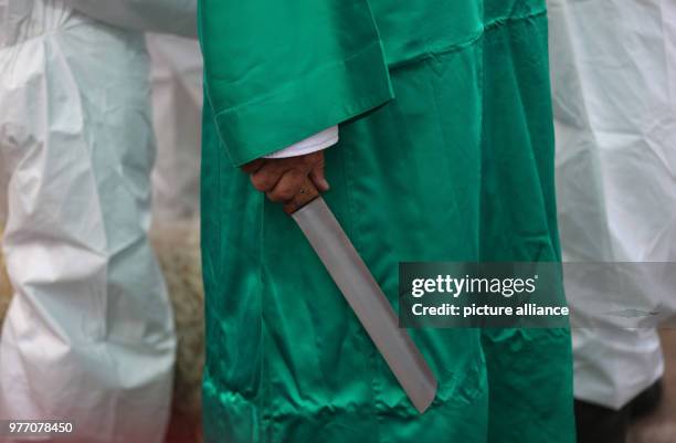 Dpatop - A member of the Samaritan community holds a knife before slaughtering the Passover Lamb to mark the Passover Sacrifice ritual, at Mount...