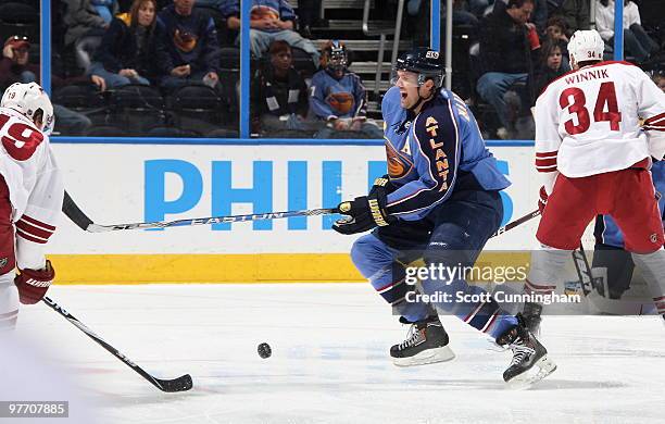 Ron Hainsey of the Atlanta Thrashers grimaces after blocking a shot by Shane Doan of the Phoenix Coyotes at Philips Arena on March 14, 2010 in...