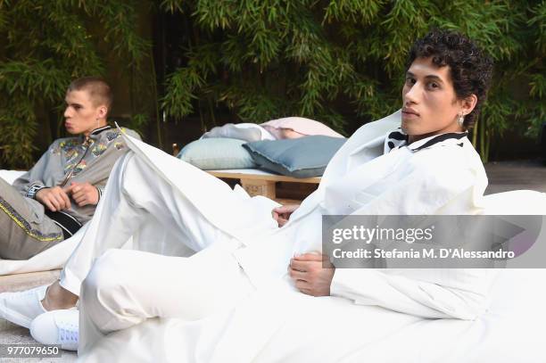 Models pose at Triple RRR presentation during Milan Men's Fashion Week Spring/Summer 2019 on June 17, 2018 in Milan, Italy.