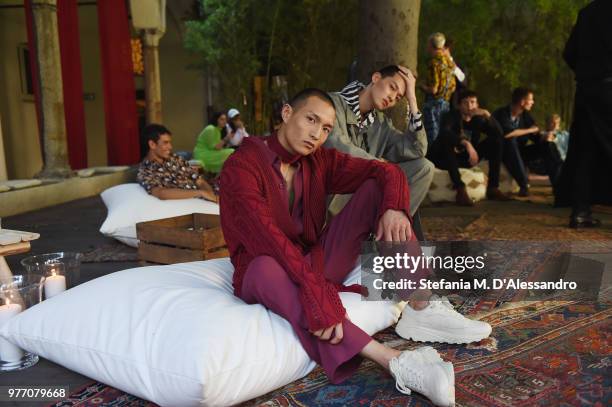 Models pose at Triple RRR presentation during Milan Men's Fashion Week Spring/Summer 2019 on June 17, 2018 in Milan, Italy.