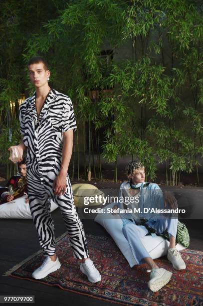 Models pose at Triple RRR presentation during Milan Men's Fashion Week Spring/Summer 2019 on June 17, 2018 in Milan, Italy.