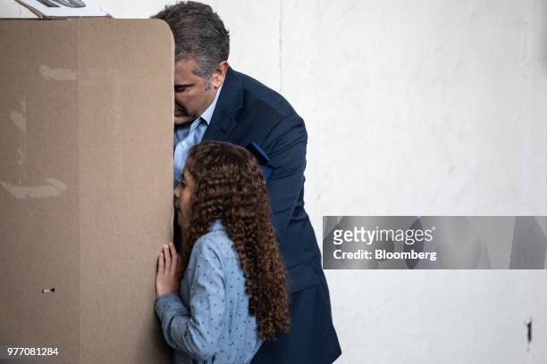 Ivan Duque, presidential candidate for the Democratic Center Party, marks a ballot inside a polling station during the second round of presidential...