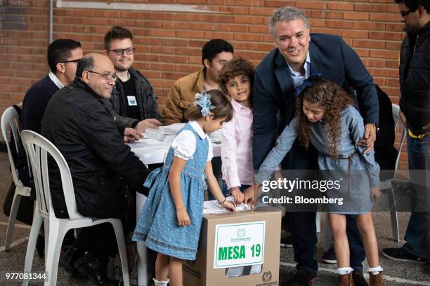 Ivan Duque, presidential candidate for the Democratic Center Party, right, casts his ballot inside a polling station during the second round of...
