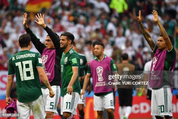 Mexico's defender Erick Gutierrez, Mexico's forward Carlos Vela and Mexico's forward Javier Aquino celebrate their 1-0 victory at the end of the...