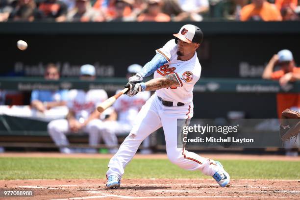 Jace Peterson of the Baltimore Orioles singles, knocking in Jonathan Schoop in the second inning during a baseball game against the Miami Marlins at...