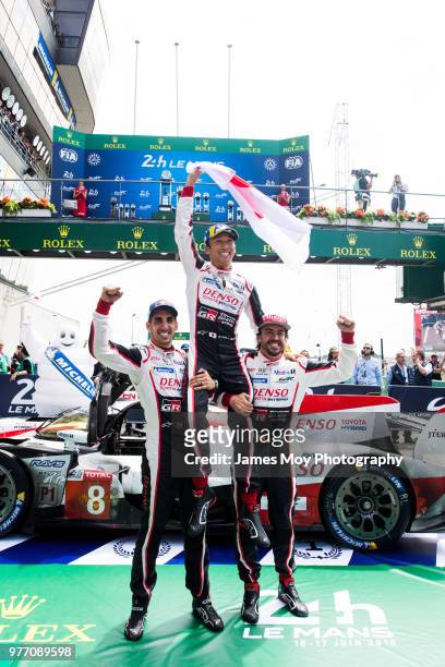 Race winners Toyota Gazoo Racing - Fernando Alonso of Spain, Kazuki Nakajima of Japan and Sebastien Buemi of Switzerland, celebrate in parc ferme at...
