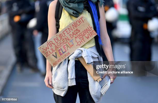 April 2018, Germany, Berlin: A participant of a demonstration carries a sign reading 'Wir duerfen nicht zulassen, dass Vielfalt missbraucht wird -...