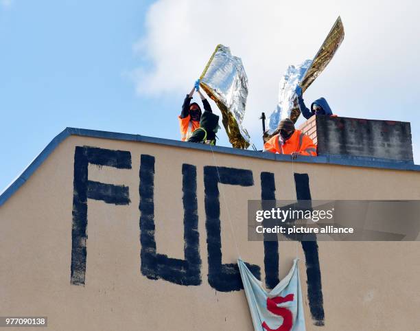 Dpatop - 30 April 2018, Germany, Berlin: Acivisits unveil a banner reading 'Stadt fuer alle' at a facade during a demonstration in Wedding district....