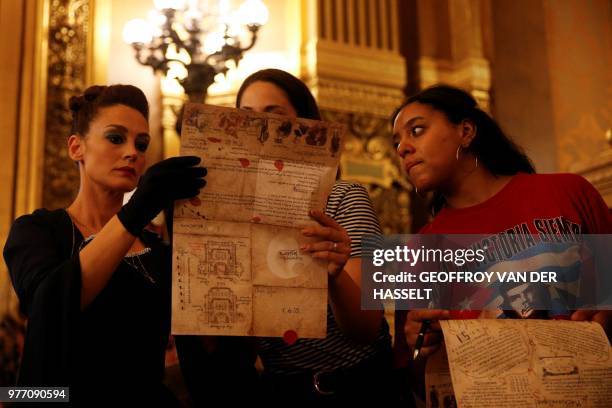 An actress speaks to people taking part in an "escape game" session at the Opera Garnier in Paris, on June 4, 2018. - Participants of these games are...