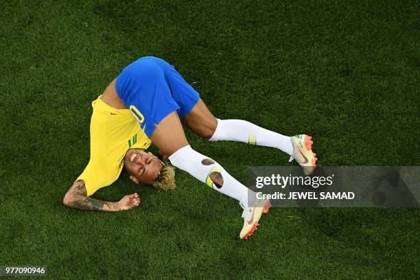 Brazil's forward Neymar falls during the Russia 2018 World Cup Group E football match between Brazil and Switzerland at the Rostov Arena in...