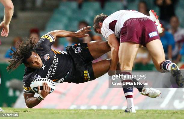 Lote Tuqiri of the Tigers is tackled during the round one NRL match between the Wests Tigers and the Manly Warringah Sea Eagles at the Sydney...