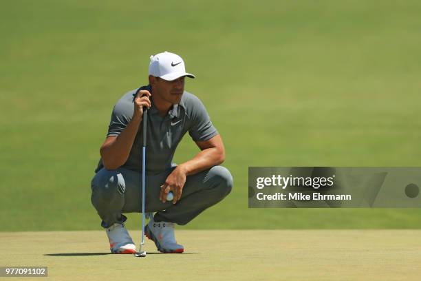 Brooks Koepka of the United States prepares to putt on the first green during the final round of the 2018 U.S. Open at Shinnecock Hills Golf Club on...