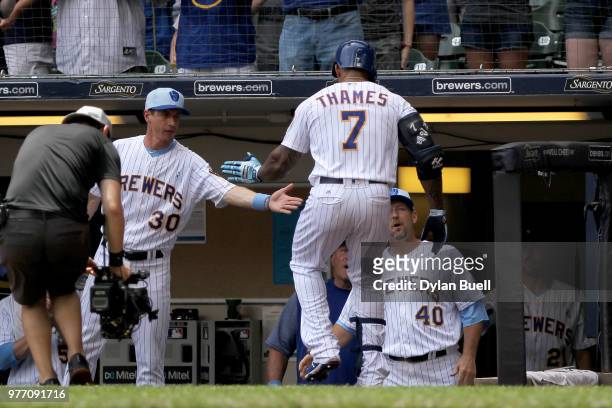 Manager Craig Counsell of the Milwaukee Brewers congratulates Eric Thames after Thames hit a home run in the first inning against the Philadelphia...