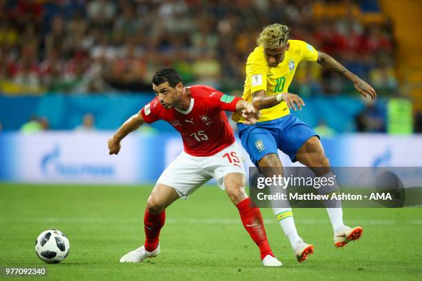 Neymar of Brazil battles for the ball with Blerim Dzemaili of Switzerland during the 2018 FIFA World Cup Russia group E match between Brazil and...