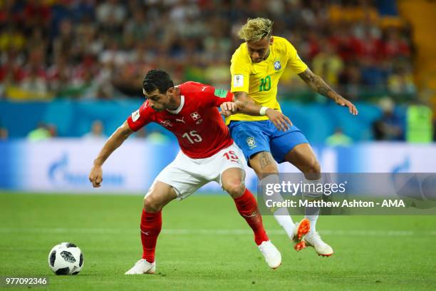 Neymar of Brazil battles for the ball with Blerim Dzemaili of Switzerland during the 2018 FIFA World Cup Russia group E match between Brazil and...