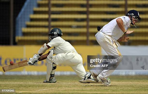 Bangladeshi cricketer Afthab Ahmad plays a shot as England cricketer Ian Bell jumps during the fourth day of the first Test match between Bangladesh...