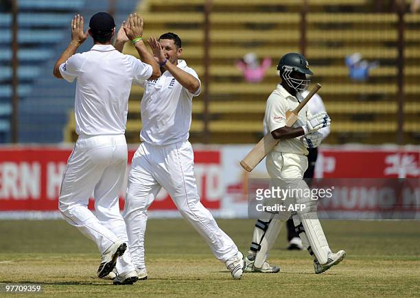 England cricketer Tim Bresnan celebrates with his teammate Kevin Pietersen after the dismissal of the Bangladeshi cricketer Afthab Ahmad during the...