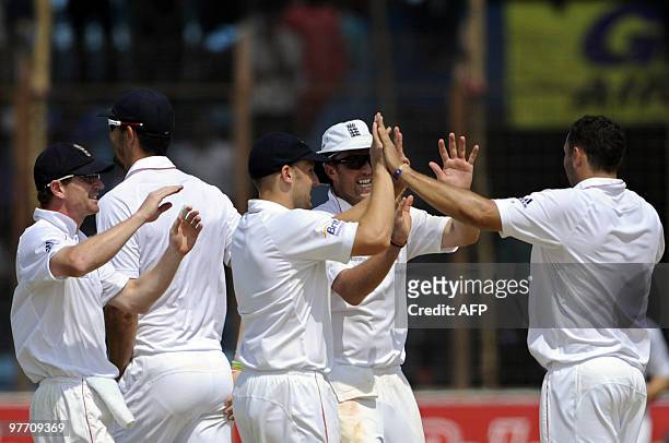 England cricketer Tim Bresnan celebrates with his teammates the dismissal of unseen Bangladeshi cricketer Afthab Ahmad during the fourth day of the...