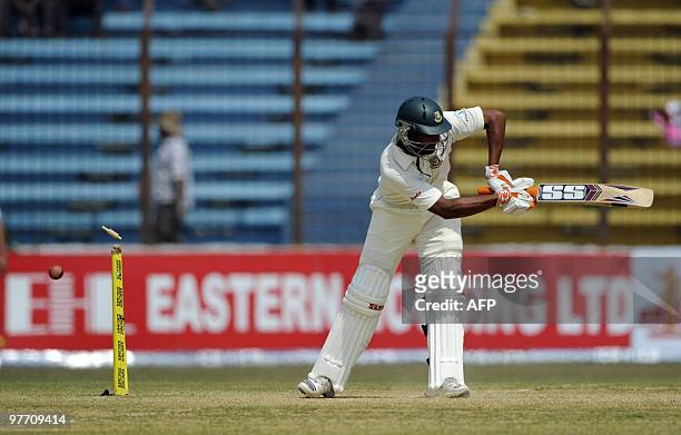 Bangladeshi cricketer Mahmudullah Riyad is bowled by the unseen England cricketer Tim Bresnan during the fourth day of the first Test match between...