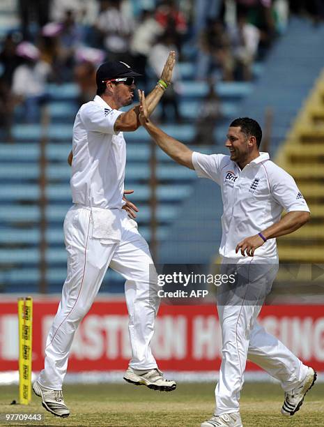 England cricketer Tim Bresnan celebrates with his teammate Kevin Pietersen after the dismissal of the unseen Bangladeshi cricketer Mahmudullah Riyad...