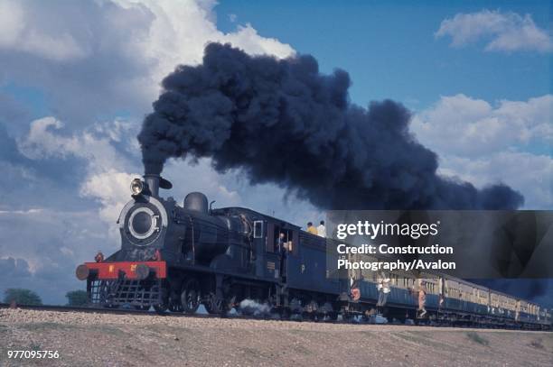 Pakistan Railways British built inside cylinder SPS class 4-4-0 No 2999 freshly overhauled at Moghulpura Works Lahore leaves Malakwal for Sargodha...