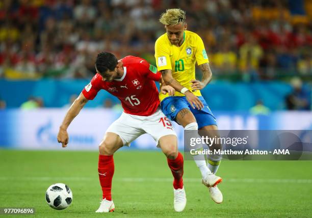Neymar of Brazil battles for the ball with Blerim Dzemaili of Switzerland during the 2018 FIFA World Cup Russia group E match between Brazil and...