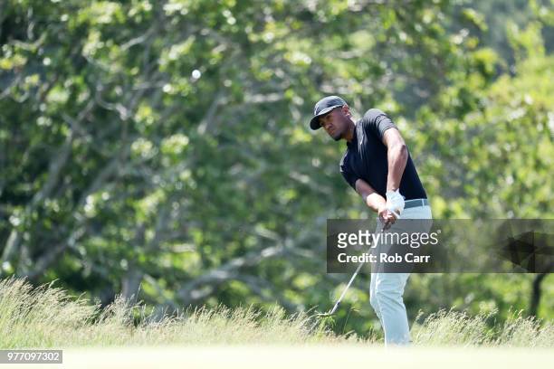 Tony Finau of the United States plays a shot from the fescue into the second green during the final round of the 2018 U.S. Open at Shinnecock Hills...