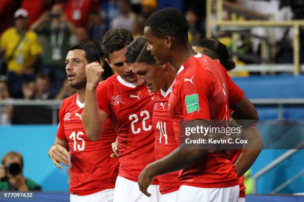 Steven Zuber of Switzerland celebrates with team mates Fabian Schaer and Manuel Akanji after scoring his team's first goal during the 2018 FIFA World...